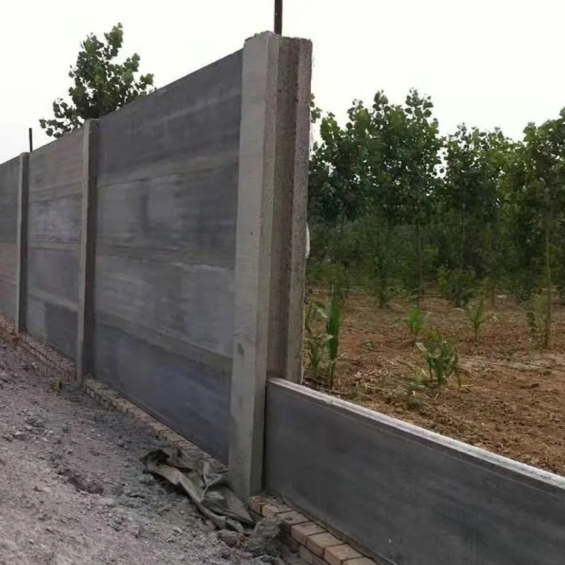 Precast concrete wall panels forming a perimeter fence